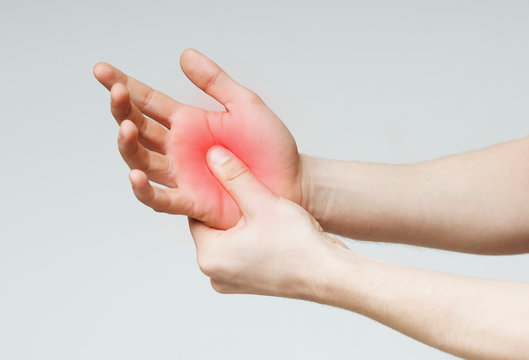 Woman massaging hand to stop palm ache
