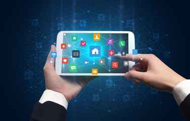 Hand using tablet with colorful bounce application symbols and icons concept
