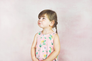 Young little and funny girl in a studio shot