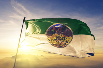 Yala province of Thailand flag waving on the top sunrise mist fog