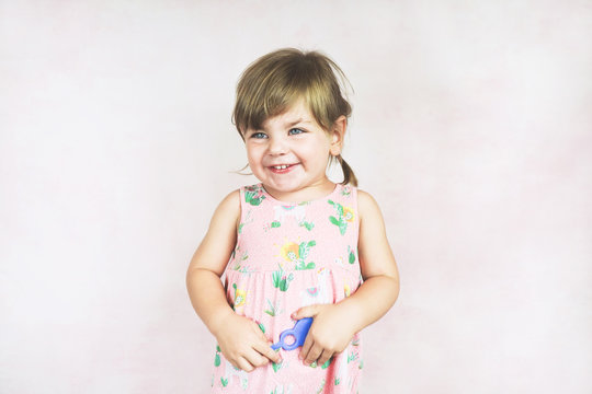 Young little and funny girl in a studio shot