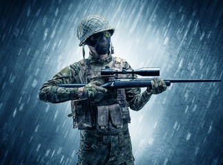 Armed soldier standing in rainy weather
