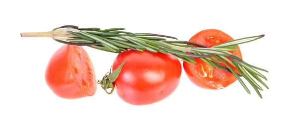 Red tomatoes and fresh green rosemary isolated on white background. Ingredients for vegetable salad