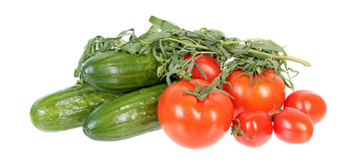 Fresh green cucumbers, red tomatoes and bundle of tarragon isolated on white background. Ingredients for vegetable salad