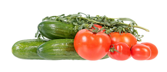 Fresh green cucumbers, red tomatoes and bundle of tarragon isolated on white background. Ingredients for vegetable salad
