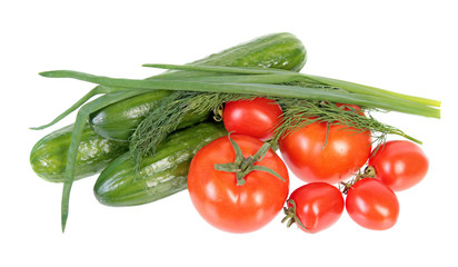 Fresh green cucumbers, red tomatoes and green dill and onion leaves isolated on white background. Ingredients for vegetable salad