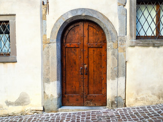 outdoor brown wooden door in medieval urban house
