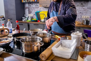 Chef puts the slices of fish with batter in the pan with butter. Master class in the kitchen. The process of cooking. Step by step. Tutorial. Close-up