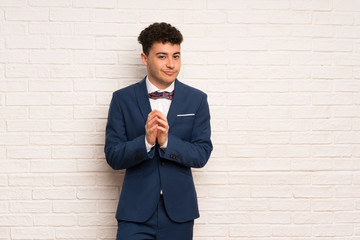 Man in suit and bow tie scheming something