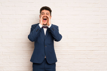 Man in suit and bow tie shouting and announcing something