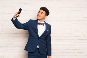 Man in suit and bow tie making a selfie