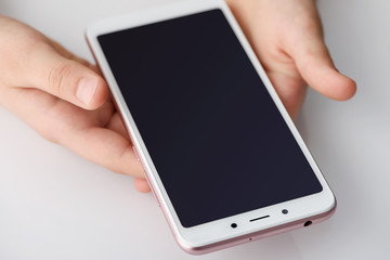 Smartphone in the hands of the girl.