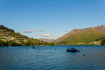peaceful landscape during sunset with calm sky above the lake and mountain range