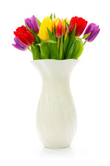 Fresh multi colored tulips flowers in a vase isolated on a white background