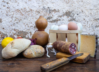 Traditional spanish food on an old wooden table, Iberian pork sausages, bread, eggs, cheese and...