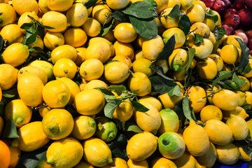 Ripe yellow lemons, lie background in the bazaar.