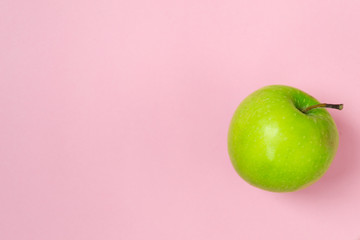 Green apple isolated on pink background