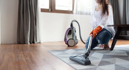 Woman using vacuum cleaner.