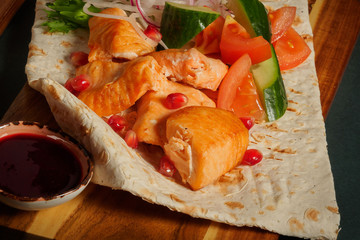 salmon shashlik with vegetables pomegranate with cranberry sauce served on pita