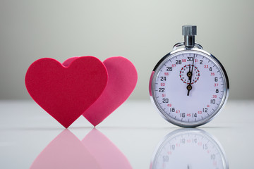 Stopwatch Near Pink And Red Heart Shape