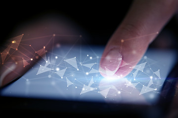 Finger touching phone with human network concept and dark background
