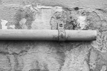 old metal pipe on a dilapidated wall