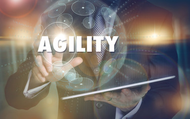 A hand selecting a Agility business concept on a futuristic computer display.
