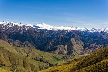 idillic landscape with mountain range, brown hills during sunny day, perfect hiking area