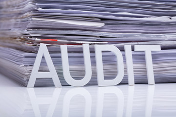 Audit Word And Stacked Document On Desk