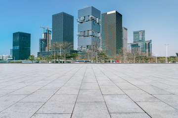 Urban skyscrapers with empty square floor tiles