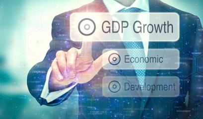 A business man selection a button on a futuristic display with a GDP Growth concept written on it.