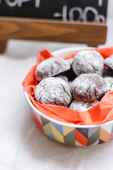 Round delicious chocolates and cookies in a plate on a plain background