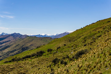Naklejka premium idillic landscape with mountain range, brown hills during sunny day, perfect hiking area, footpath leading into mountains 