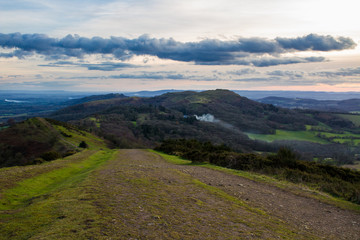Fototapeta na wymiar Path leading down jubilee hill with herefordshire beacon and southern part of the malvern hills in the background