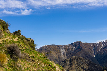 Fototapeta premium idillic landscape with mountain range, brown hills during sunny day, perfect hiking area