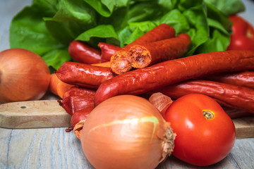 Traditional homemade smoked sausage for barbeque with fresh organic vegetable in the background