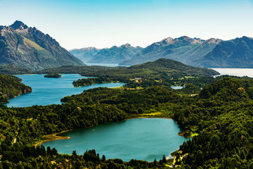Fototapeta na wymiar Scenic aerial nature colorful landscape photo of blue aquamarine lakes, rivers, Andes mountains, and green tree forest in Patagonia, Argentina