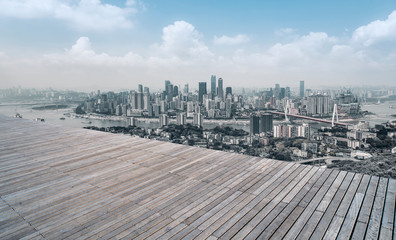 Naklejka premium Urban skyscrapers with empty square floor tiles