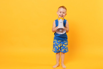 Kid boy 3-4 years old in blue beach summer clothes hold speak in megaphone isolated on bright yellow orange background children studio portrait. People childhood lifestyle concept Mock up copy space.