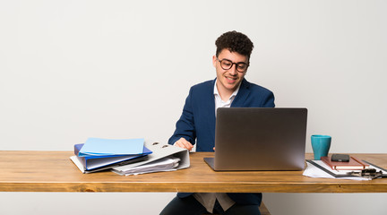 Business man in a office with glasses and happy