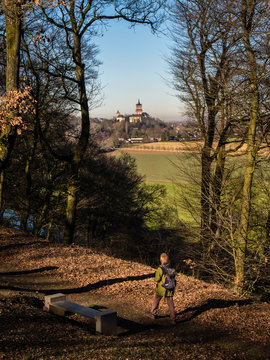 Single male pedestrian overseeing flat rural terrain towards a castle at Cleve, Germany,