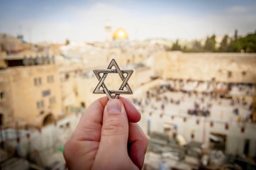 JERUSALEM, ISRAEL. February 15, 2019. Hand holding a Star of David, a Jewish religious symbol...