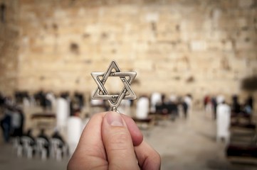 JERUSALEM, ISRAEL. February 15, 2019. Hand holding a Star of David, a Jewish religious symbol...