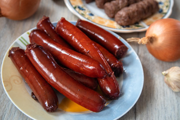Grilled traditional homemade smoked sausage with salad and mashed potato