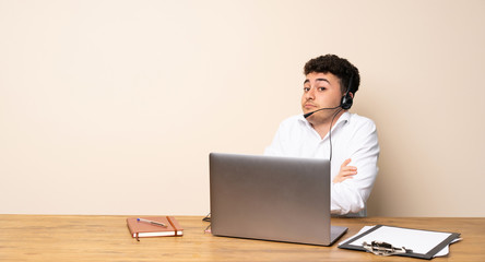 Telemarketer man making doubts gesture while lifting the shoulders