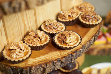 Sweet tartlet snack with walnut and honey, close-up. Buffet catering food
