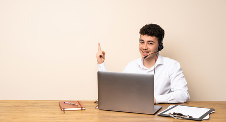 Telemarketer man showing and lifting a finger in sign of the best