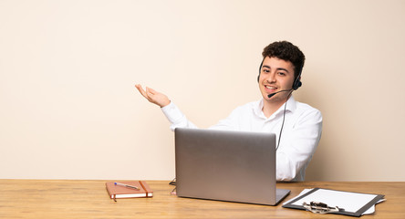 Telemarketer man presenting an idea while looking smiling towards