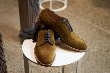 Elegant mens leather shoes in luxury store shop.