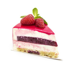 pink raspberry cake with raspberry jam on a white plate with mint